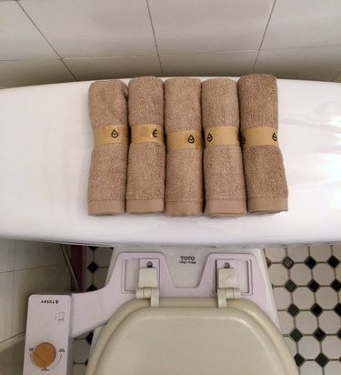 Tushy Bamboo Bum Towels arranged on top of Toto toilet featuring Tushy classic bidet