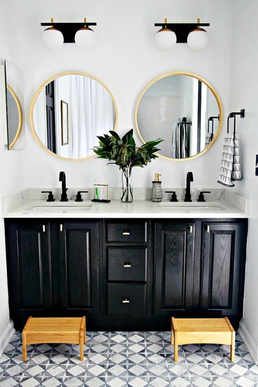 double sink bathroom lighting ideas in black and white space with round mirrors