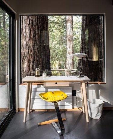 home office in modern tiny house with oversize windows