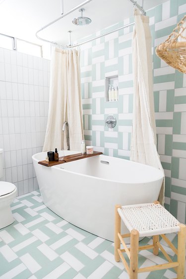 light, bright bathroom with stand-alone tub and linen shower curtain by Parachute