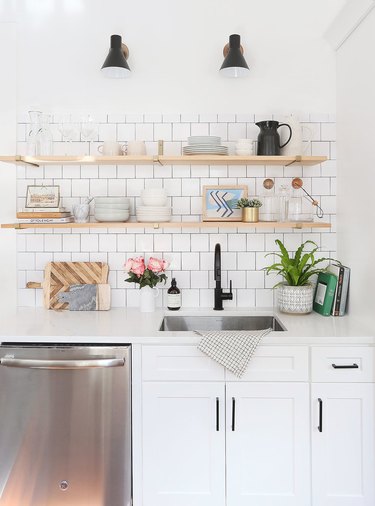 white kitchen cabinets with black hardware and open shelving