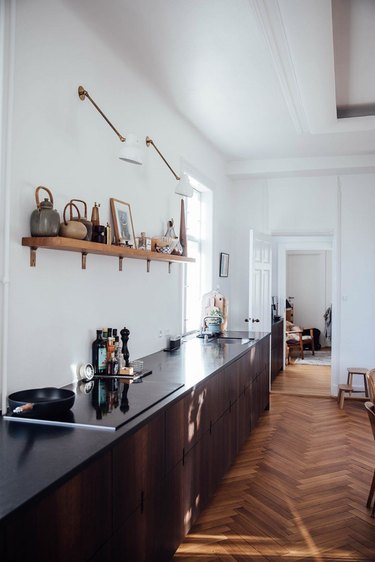 kitchen with dark wood cabinets without hardware and open shelving