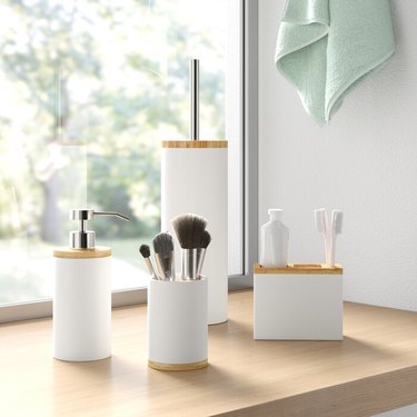 white and light wood bathroom accessory set
