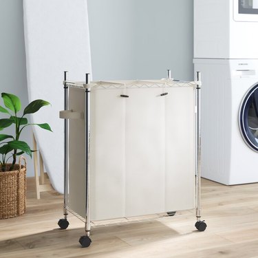 silver and beige rolling laundry sorter