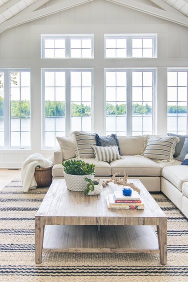 fresh white coastal family room with striped jute rug