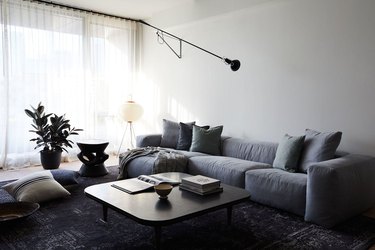 masculine boho decor in white living room with gray furniture