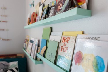Baby blue bookshelves in kid's room on white wall