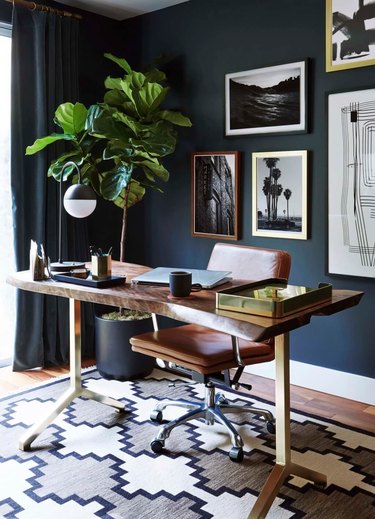 masculine boho decor in dark blue home office with desk and chair