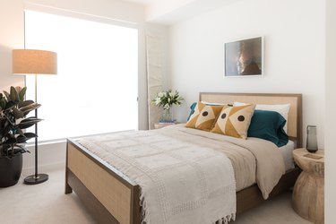 white bedroom with cane bed