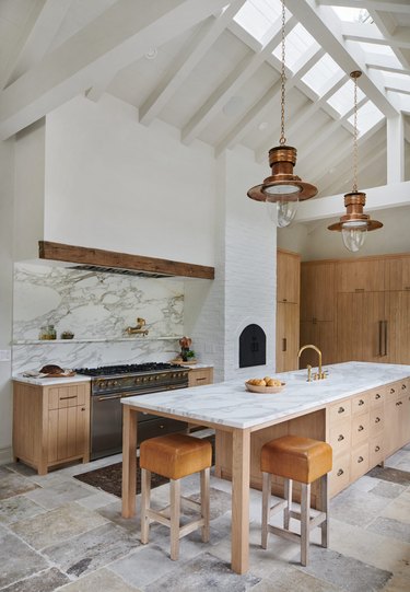 rustic white kitchen with high ceilings and marble kitchen island