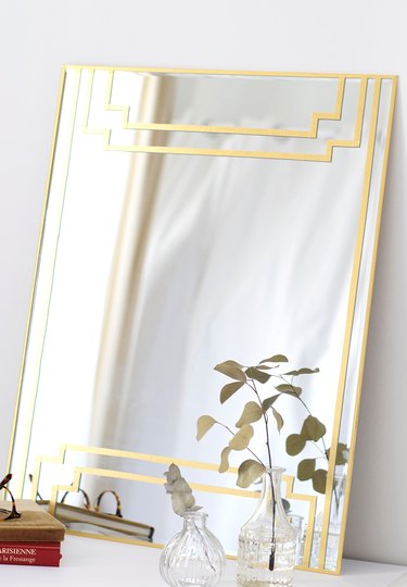 Art deco DIY project with gilded mirror on white tabletop