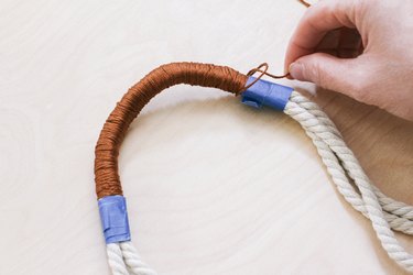 Securing end of embroidery floss with loop