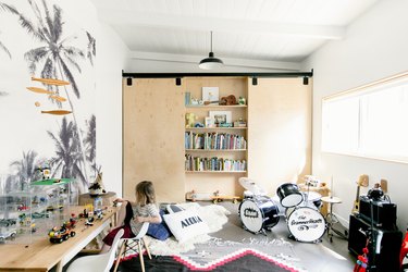 Playroom with musical instruments and toys and hidden bookshelf