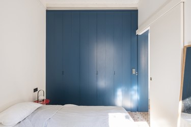 white bedroom with blue paint color closet doors