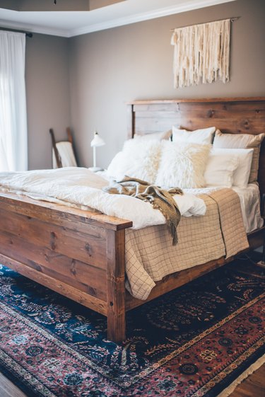 bedroom rug ideas with a colorful rug beneath wooden bed