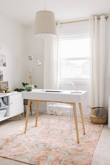 minimalist modern home office design with patterned rug and ceiling light