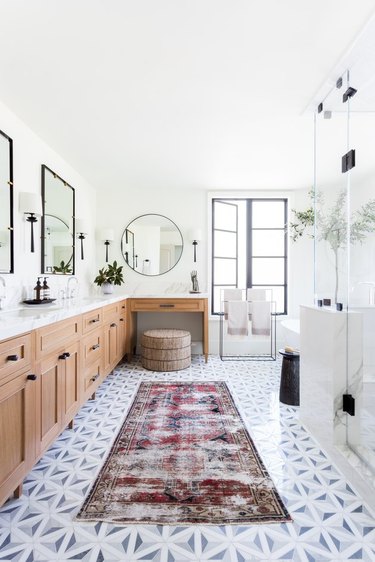 l-shaped master bathroom vanity in chic bathroom with patterned runner