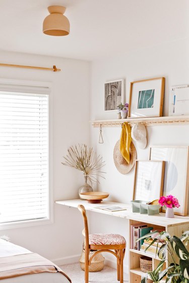 minimalist modern home office design with rattan desk chair and framed art