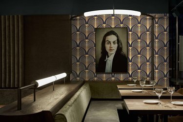 Art deco room with patterned wallpaper and portrait of girl