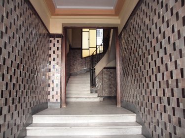 Art deco hallway with patterned tile and staircase