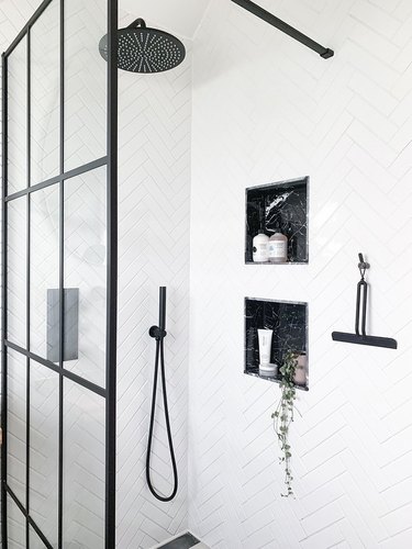 monochrome shower room with wall niches for shower storage ideas