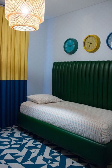 color-blocked bedroom with green channel tufted daybed