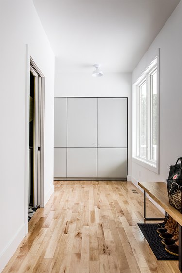 Wood plank minimalist flooring in cream and white entryway