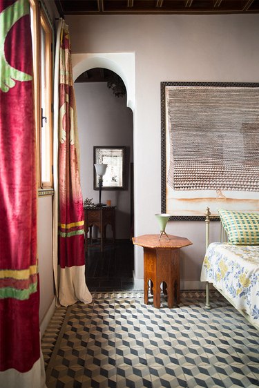 pattern filled bedroom with moroccan textiles and vintage wood table