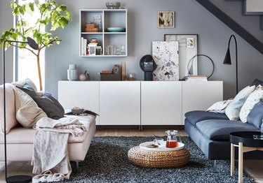 IKEA living room minimalist furniture with white credenza and rattan floor pouf