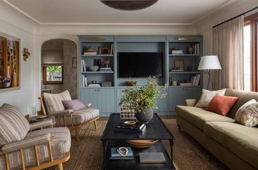 family room furniture with striped accent chairs and teal built-in shelves