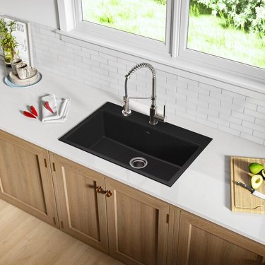 black minimalist kitchen sink in kitchen with white subway tile