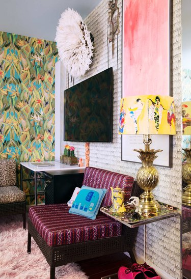 pattern filled living room with ornate lamp and tropical wallpaper