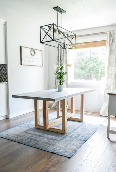 DIY minimalist dining table with concrete top and geometric wood legs