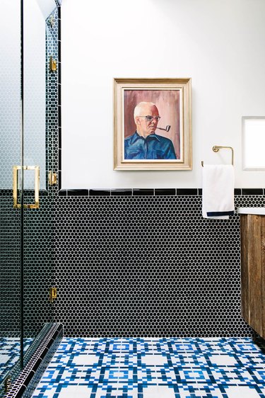 bold bathroom tile with brass accents, reclaimed wood vanity and vintage oil painting