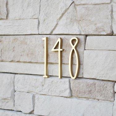 art deco modern house numbers on stone siding