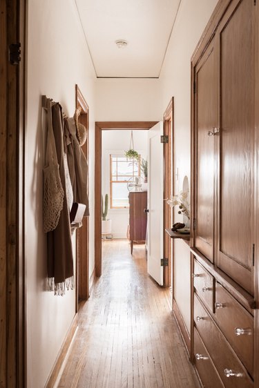 Built-in cabinets and coat hooks as hallway storage