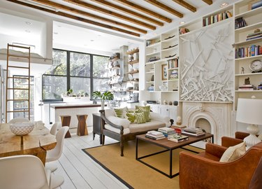 small living room idea with exposed ceiling beams and open shelving