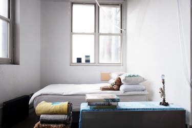 Loft with white walls and simply made bed