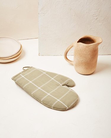 checkered oven mitt in light green color with pitcher nearby