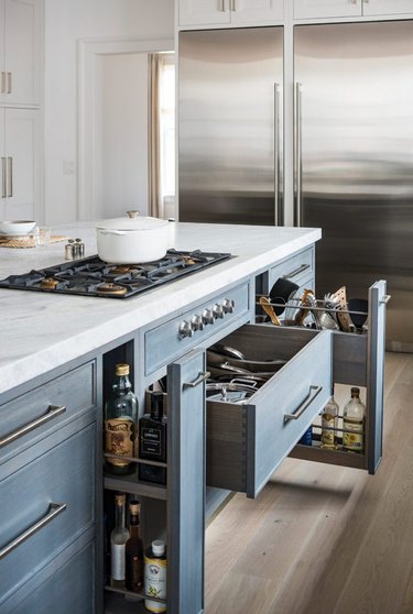 Kitchen island with stove and blue storage drawers