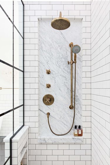 shower storage ideas with marble inlay and brass shower head