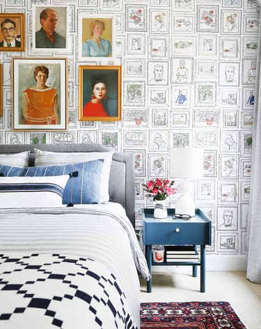 guest bedroom decorating idea with quirky wallpaper and vintage artwork