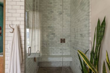 walk-in shower shower with grey tile walls and glass wall