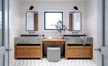 bathroom makeup vanity between double concrete sinks