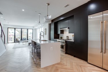modern black tall kitchen cabinets and herringbone floors