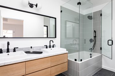 bathroom with tub/shower combo and double-sink vanity