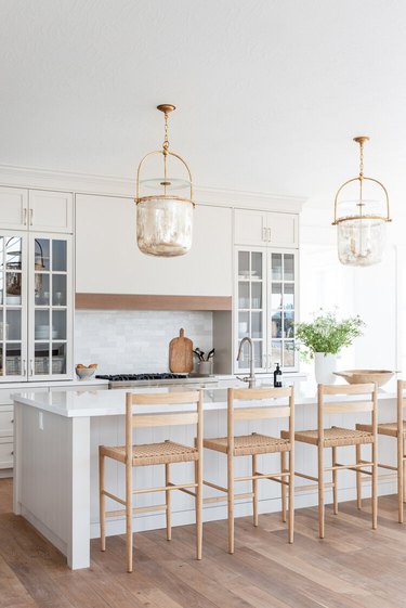 neutral kitchen with tall kitchen cabinets with glass fronts