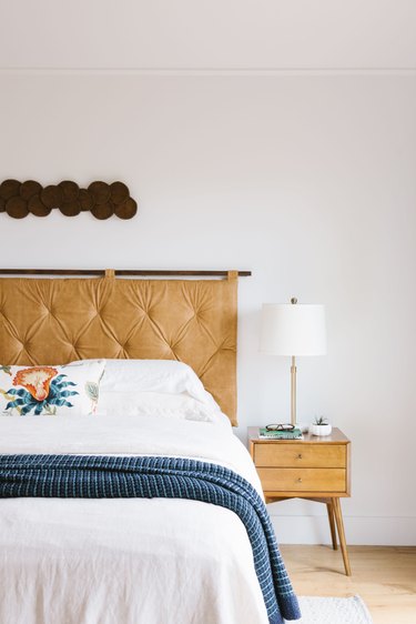 Vintage bedroom idea with upholstered headboard