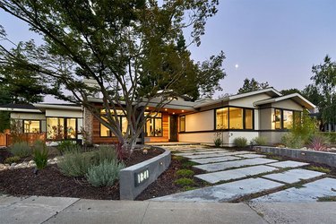 craftsman style ranch house with white exterior and concrete steps
