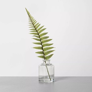 faux fern in a glass vase